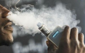 A man smokes an electronic cigarette vaporizer, also known as an e-cigarette, in Toronto